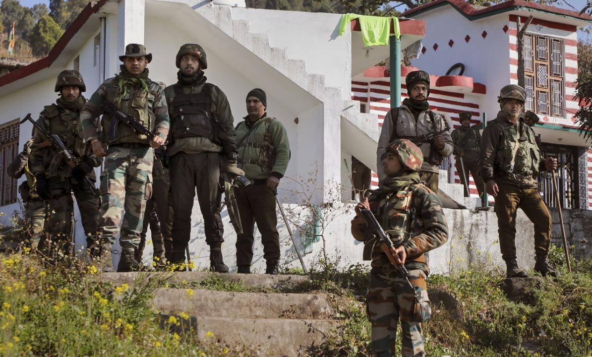Army personnel stand near the house where an IED explosion took place, at Dangri village in Rajouri district. Pic/PTI